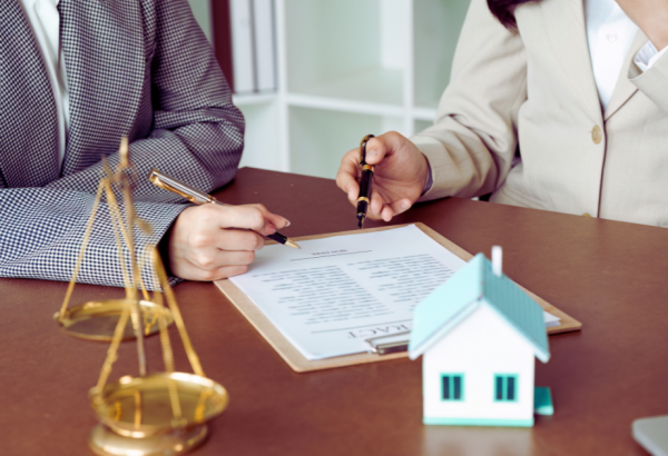 two people at a table reviewing documents